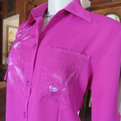As new violet colour richly embroidered button down top size 38/14. Tailored with open collar.