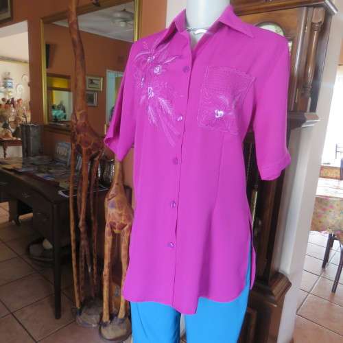 As new violet colour richly embroidered button down top size 38/14. Tailored with open collar.