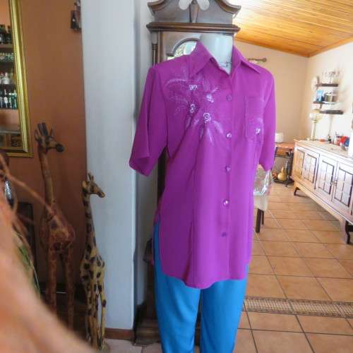 As new violet colour richly embroidered button down top size 38/14. Tailored with open collar.