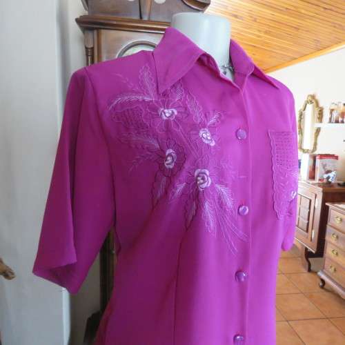 As new violet colour richly embroidered button down top size 38/14. Tailored with open collar.