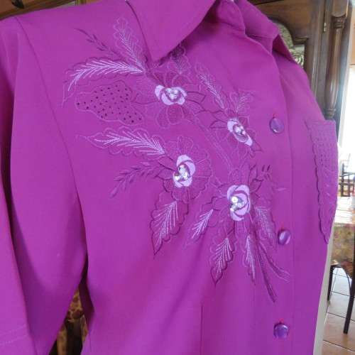 As new violet colour richly embroidered button down top size 38/14. Tailored with open collar.