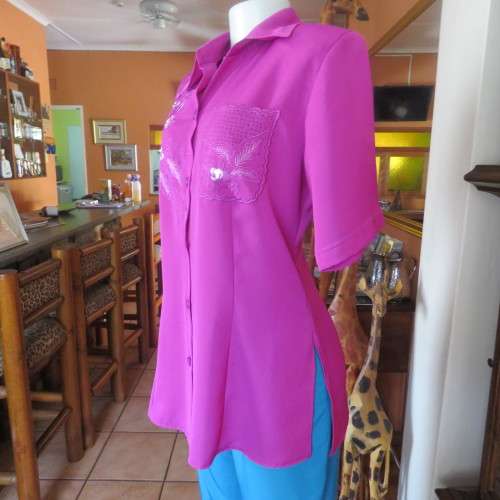 As new violet colour richly embroidered button down top size 38/14. Tailored with open collar.