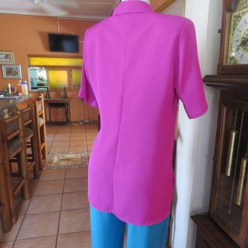 As new violet colour richly embroidered button down top size 38/14. Tailored with open collar.