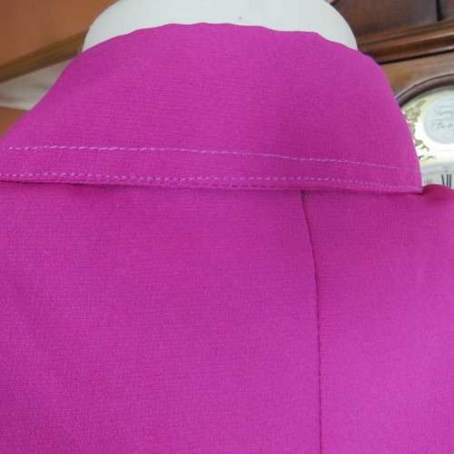 As new violet colour richly embroidered button down top size 38/14. Tailored with open collar.