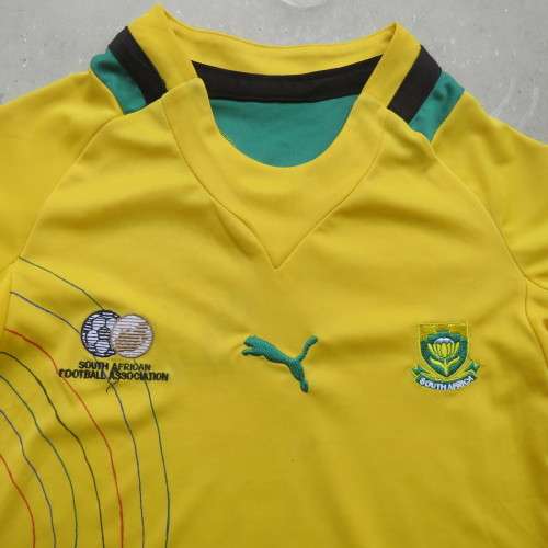 Boy`s Puma Football club yellow stretch polyester top with green/black stripe. Size 4 to 5 years.