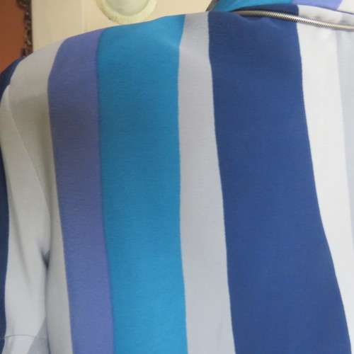 Pretty graphic patterned short sleeve top in blue,greys and lavender polyester. Size 36/12. As new