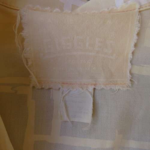Unique cropped short sleeve `GIGGLES` top in vanilla and white blocks. Size 42/18 by `DAVID CLINE`.