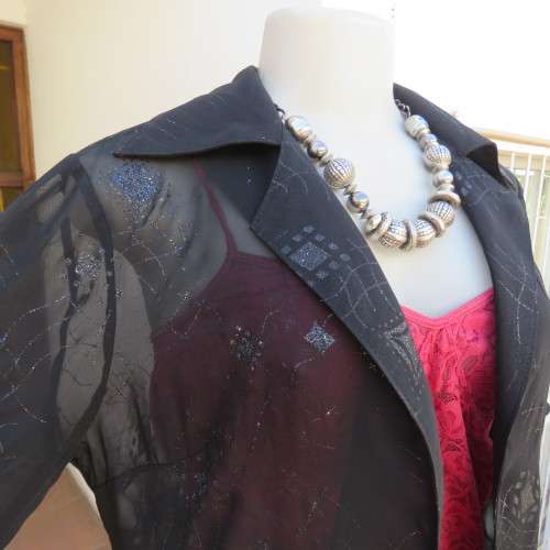 Black short sleeve open hanging glamour top with silver sparkles in diamond design size 34/10.