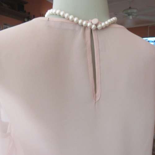 Chic little soft peach slip over cropped top by `ATMOSPHERE` in size 34/10. New condition.