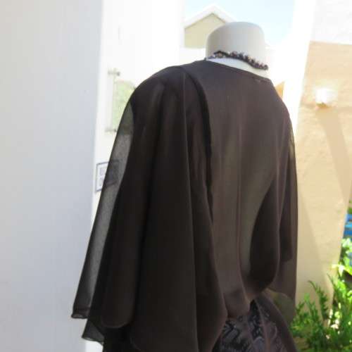 Pretty soft Flowing sheer polyester top in black. Size 40/16. Overlay loose sleeves. As new.