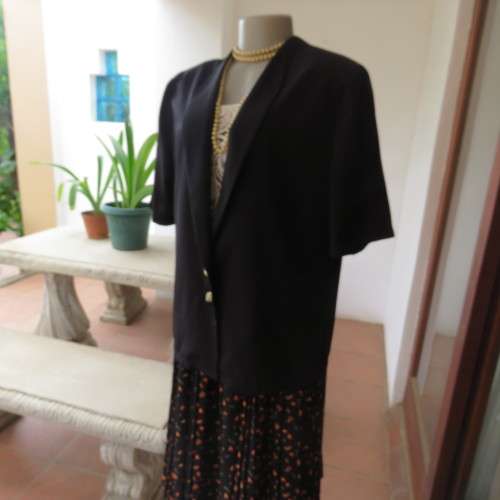 Smart black silky polyester short sleeve top/jacket with low shawl collar. Size 38/14 by DERMAR.