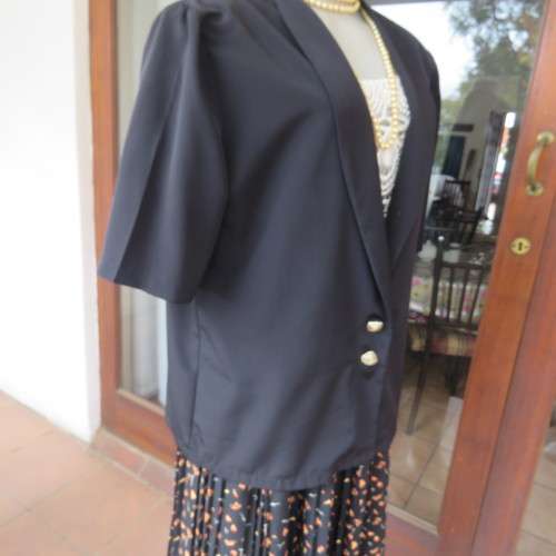 Smart black silky polyester short sleeve top/jacket with low shawl collar. Size 38/14 by DERMAR.