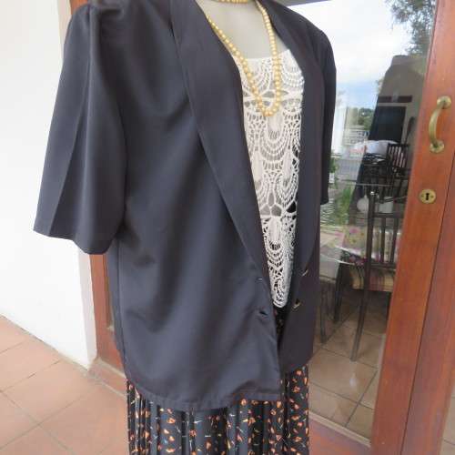 Smart black silky polyester short sleeve top/jacket with low shawl collar. Size 38/14 by DERMAR.