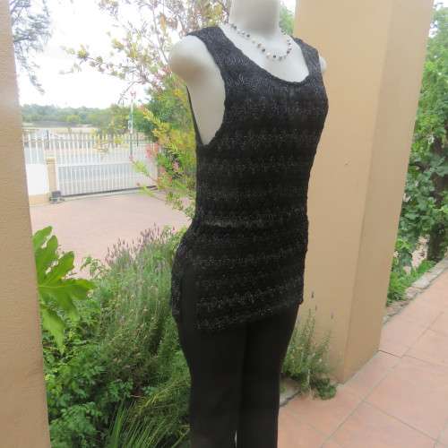 Glamour sleeveless black and silver horizontal patterned see-through top. Lined to waist. Size 34