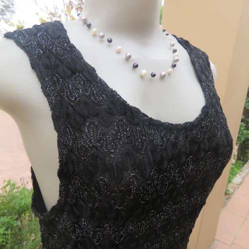 Glamour sleeveless black and silver horizontal patterned see-through top. Lined to waist. Size 34