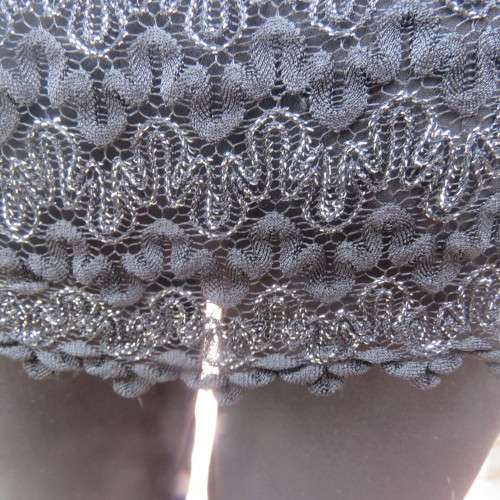 Glamour sleeveless black and silver horizontal patterned see-through top. Lined to waist. Size 34