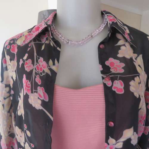 Fabulous black sheer polyester top with pink/cream posies.Size 32/8 by WOOLWORTHS.As new.