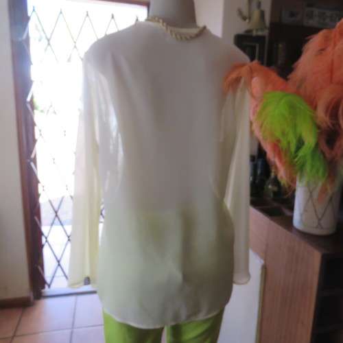 Stylish rich cream slip over long sleeve top size 38/14 with pretty embroidered neckline.By STATURE.