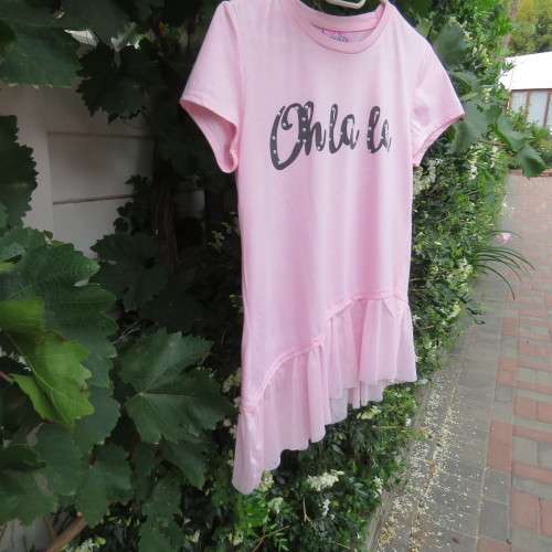 Pretty carnation pink capped sleeve slip over top with asymmetrical seamline. For 14 to 15 yr old.