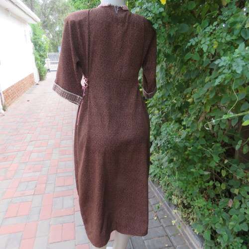 Unique ethnic low calf length dress in mottled brown/cream richly embellished. Size 34 to 36.As new