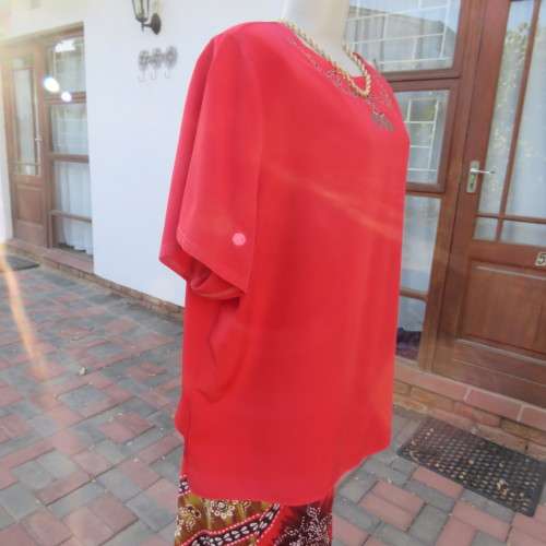 Cherry red slip over silky 100% polyester short sleeve top with stunning embroidery.Size 48.As new