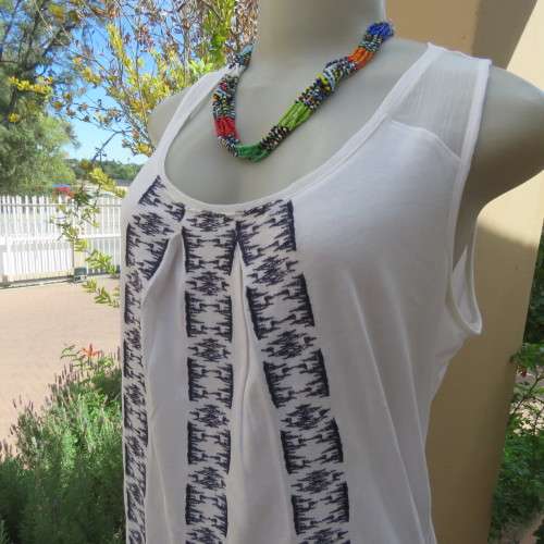 White sleeveless OLD KHAKI top with 3 front navy embroidered stripes. Size 38/14. Sheer yoke.