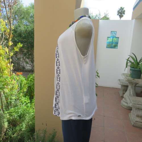 White sleeveless OLD KHAKI top with 3 front navy embroidered stripes. Size 38/14. Sheer yoke.