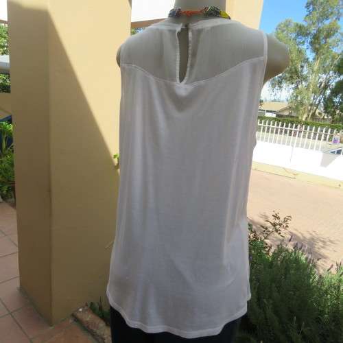 White sleeveless OLD KHAKI top with 3 front navy embroidered stripes. Size 38/14. Sheer yoke.