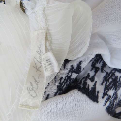 White sleeveless OLD KHAKI top with 3 front navy embroidered stripes. Size 38/14. Sheer yoke.