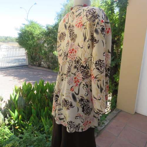 Pretty slip over silky polyester rich cream top with red and black unique designs.Size 44/20.As new
