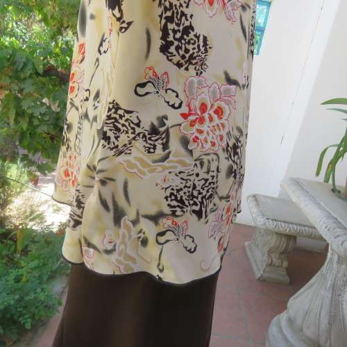 Pretty slip over silky polyester rich cream top with red and black unique designs.Size 44/20.As new