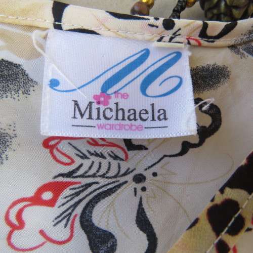 Pretty slip over silky polyester rich cream top with red and black unique designs.Size 44/20.As new