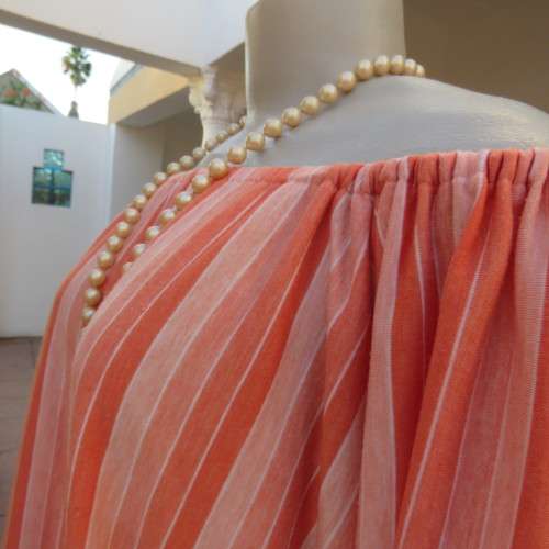 Naked shoulder vertical striped soft polycotton stretch top in shades of peach. Size 34 to 36.As new