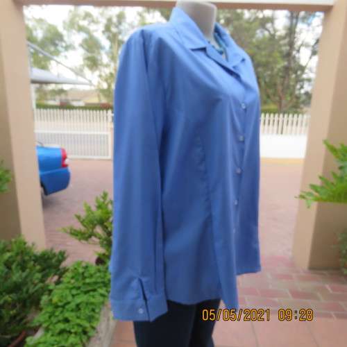 As new skyblue button down shirt with princess cut on front. Shirt collar. By ENVOY in size 42/18.