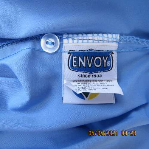 As new skyblue button down shirt with princess cut on front. Shirt collar. By ENVOY in size 42/18.