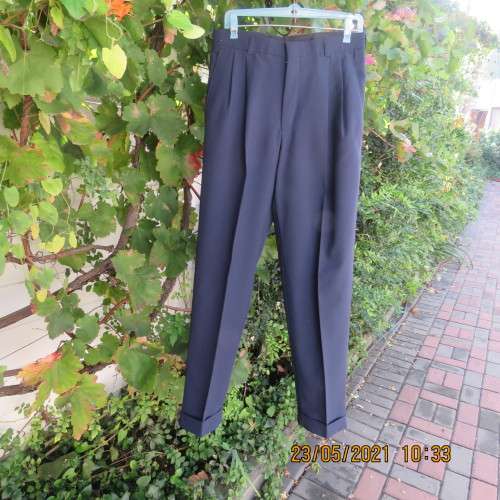 Smart navy Men`s pants by SIGNATURE in size 30. Pleats on front. Turnups on legs. New condition.