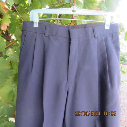 Smart navy Men`s pants by SIGNATURE in size 30. Pleats on front. Turnups on legs. New condition.