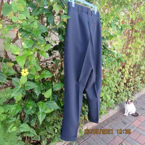 Smart navy Men`s pants by SIGNATURE in size 30. Pleats on front. Turnups on legs. New condition.