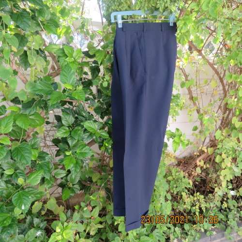 Smart navy Men`s pants by SIGNATURE in size 30. Pleats on front. Turnups on legs. New condition.