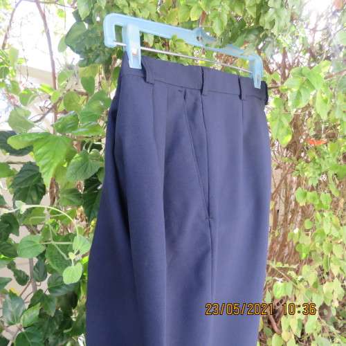 Smart navy Men`s pants by SIGNATURE in size 30. Pleats on front. Turnups on legs. New condition.