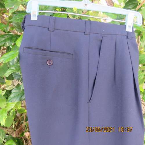 Smart navy Men`s pants by SIGNATURE in size 30. Pleats on front. Turnups on legs. New condition.