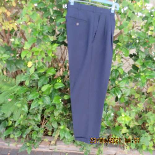 Smart navy Men`s pants by SIGNATURE in size 30. Pleats on front. Turnups on legs. New condition.