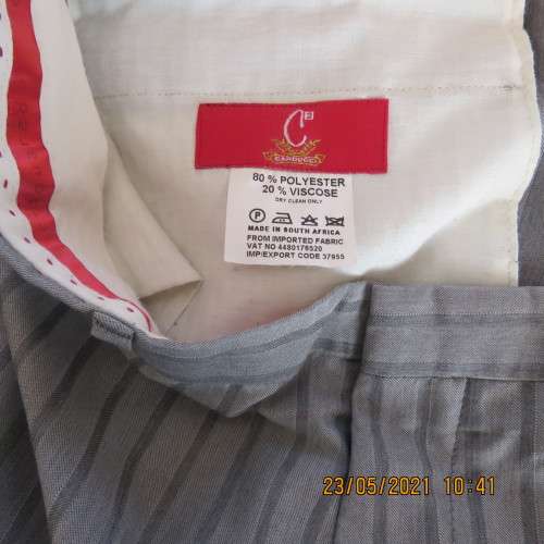 Men`s silvergrey striped pants by CARDUCCI in size 36+. Pockets sides and back. New condition