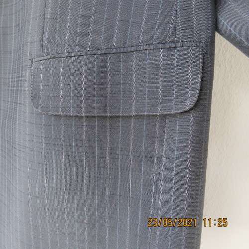 Handsome Men`s silvergrey pinstripe jacket in size 42.Used once. Washable.Pockets front and inside.