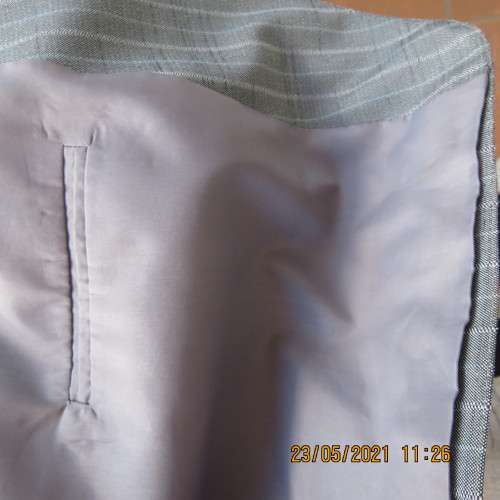 Handsome Men`s silvergrey pinstripe jacket in size 42.Used once. Washable.Pockets front and inside.