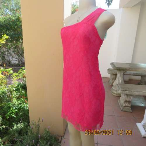 Seriously sexy pink one shoulder acrylic lace dress with stretch polyester inner. Size 34 to 36.