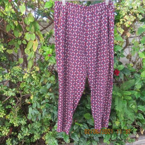 As new loose printed pants with tapered legs in maroon with navy/white pattern.Size 48/24 by DONNA C