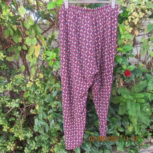 As new loose printed pants with tapered legs in maroon with navy/white pattern.Size 48/24 by DONNA C