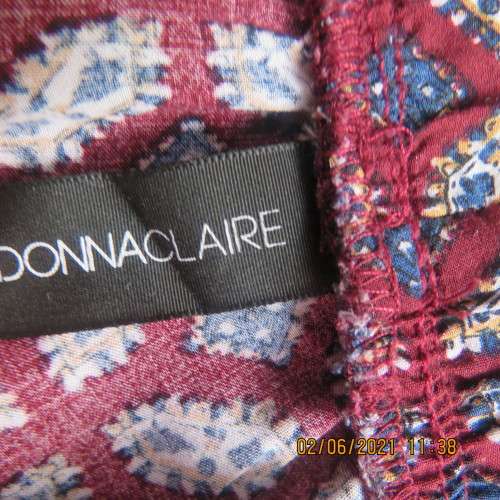 As new loose printed pants with tapered legs in maroon with navy/white pattern.Size 48/24 by DONNA C