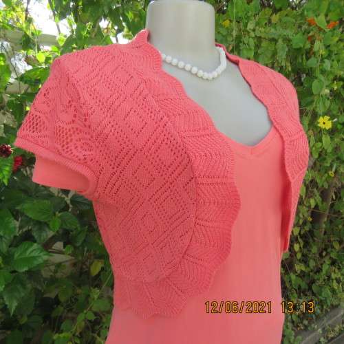 Lovely coral colour capped sleeve bolero in stretch acrylic lace. Size 34/10 by FASHION EXPRESS.